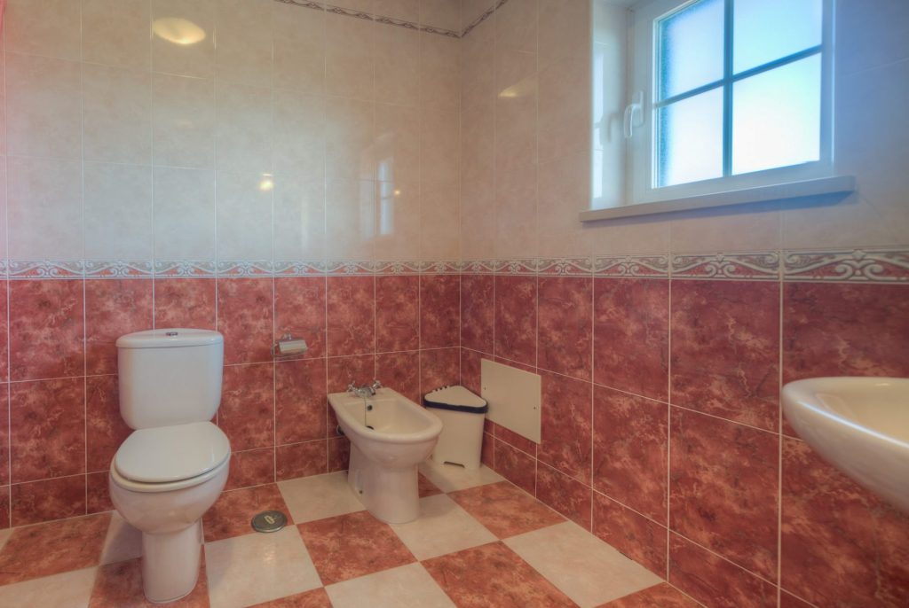 Bathroom with bath, shower, toilet and bidet.