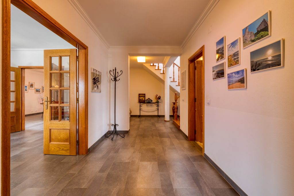Walking into the house, with the game room on your left