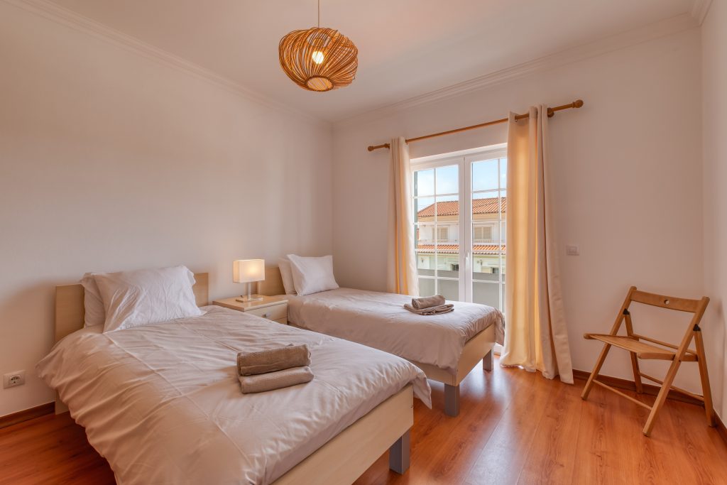 Two single beds and access to the front balcony